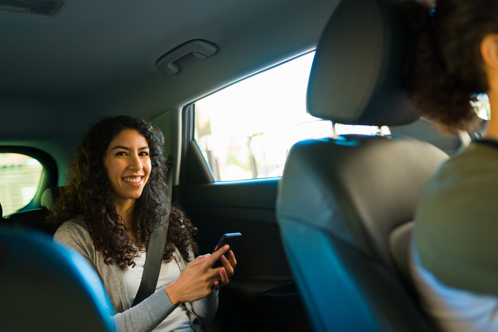 Passenger using a phone during a scheduled ride