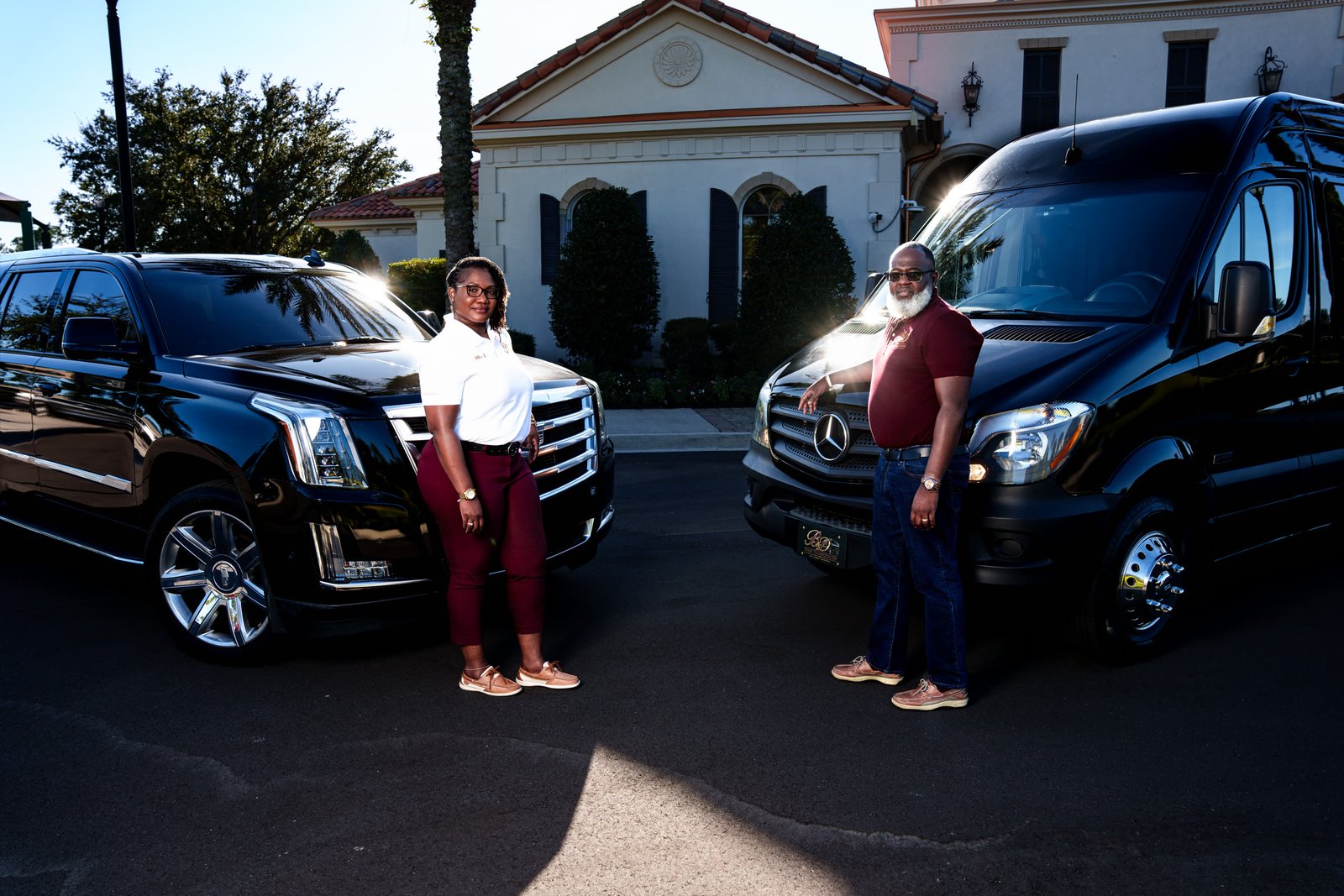 Danny and a B&D team member standing in front of the Escalade and Sprinter